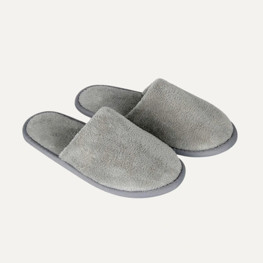 A pair of plush, open-toe slip-on slippers in a heather gray color, shown on a light off-white background.
