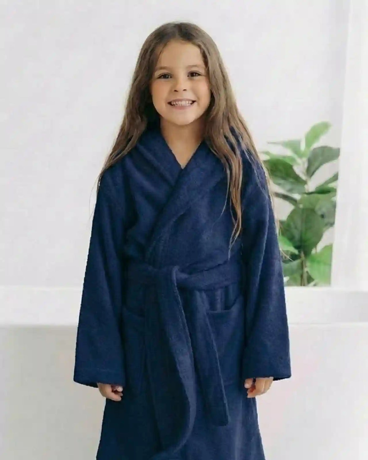 kids bathrobe blue A girl smiling to wear a kids bathrobe