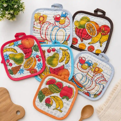 Premium quilted cotton kitchen pot holder with colorful fruit print used for safely handling hot cookware.
