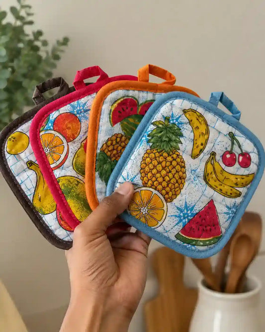  Premium quilted cotton pot holder with colorful fruit print, heat resistant kitchen hot pad for safe cooking.