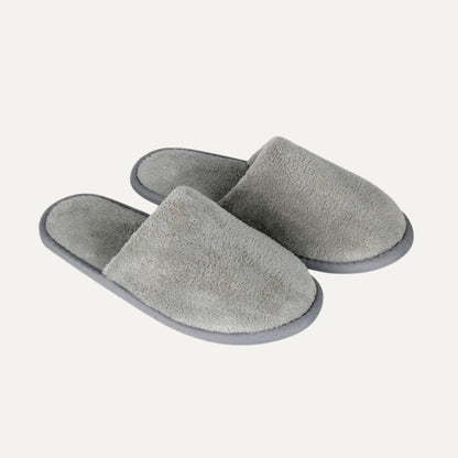 A pair of plush, open-toe slip-on slippers in a heather gray color, shown on a light off-white background.